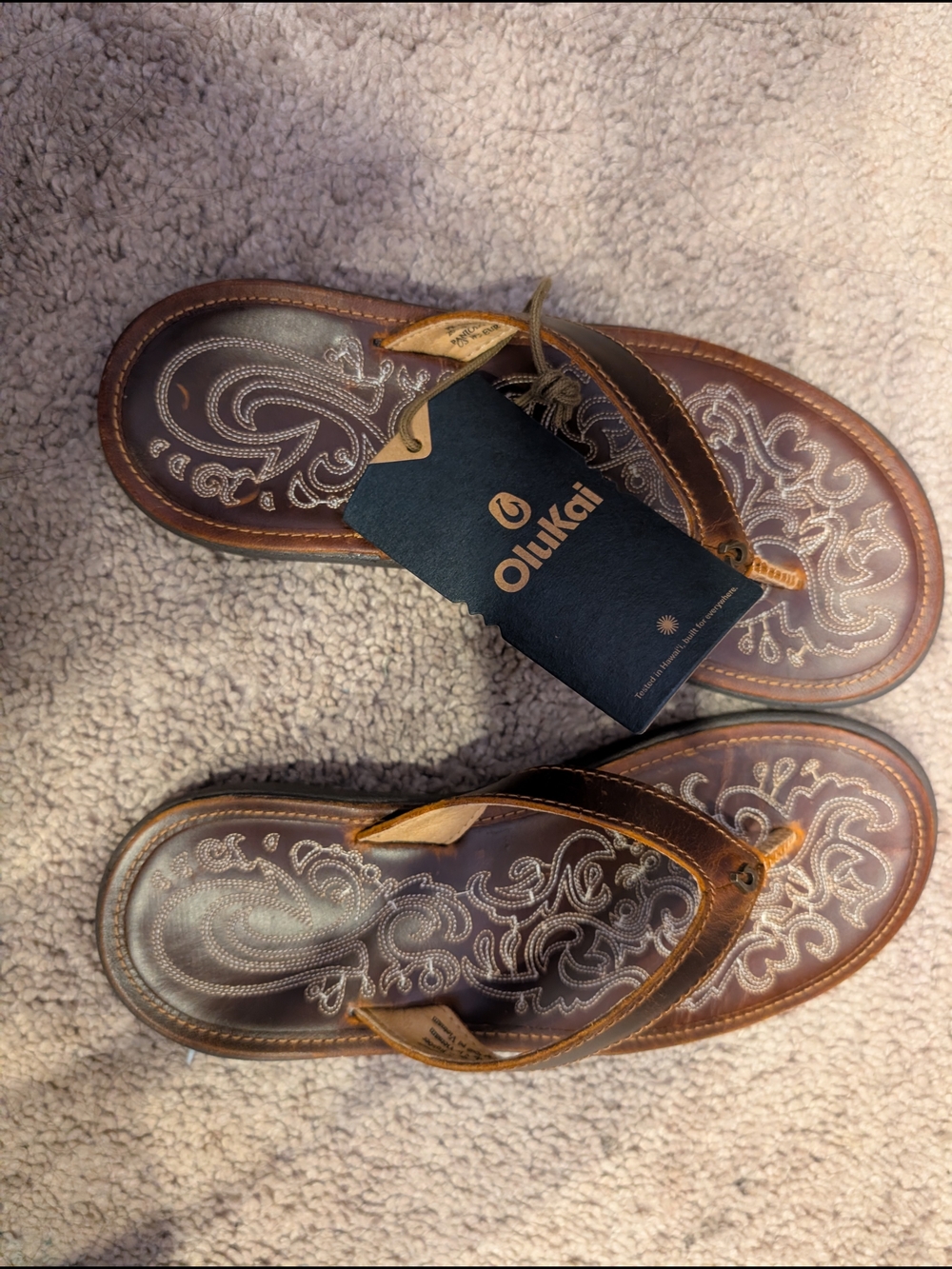 OluKai Woman's Brown Leather Flip-Flops with White Embroidered Footbed